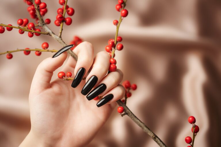 Hands of a young girl with black manicure on nails